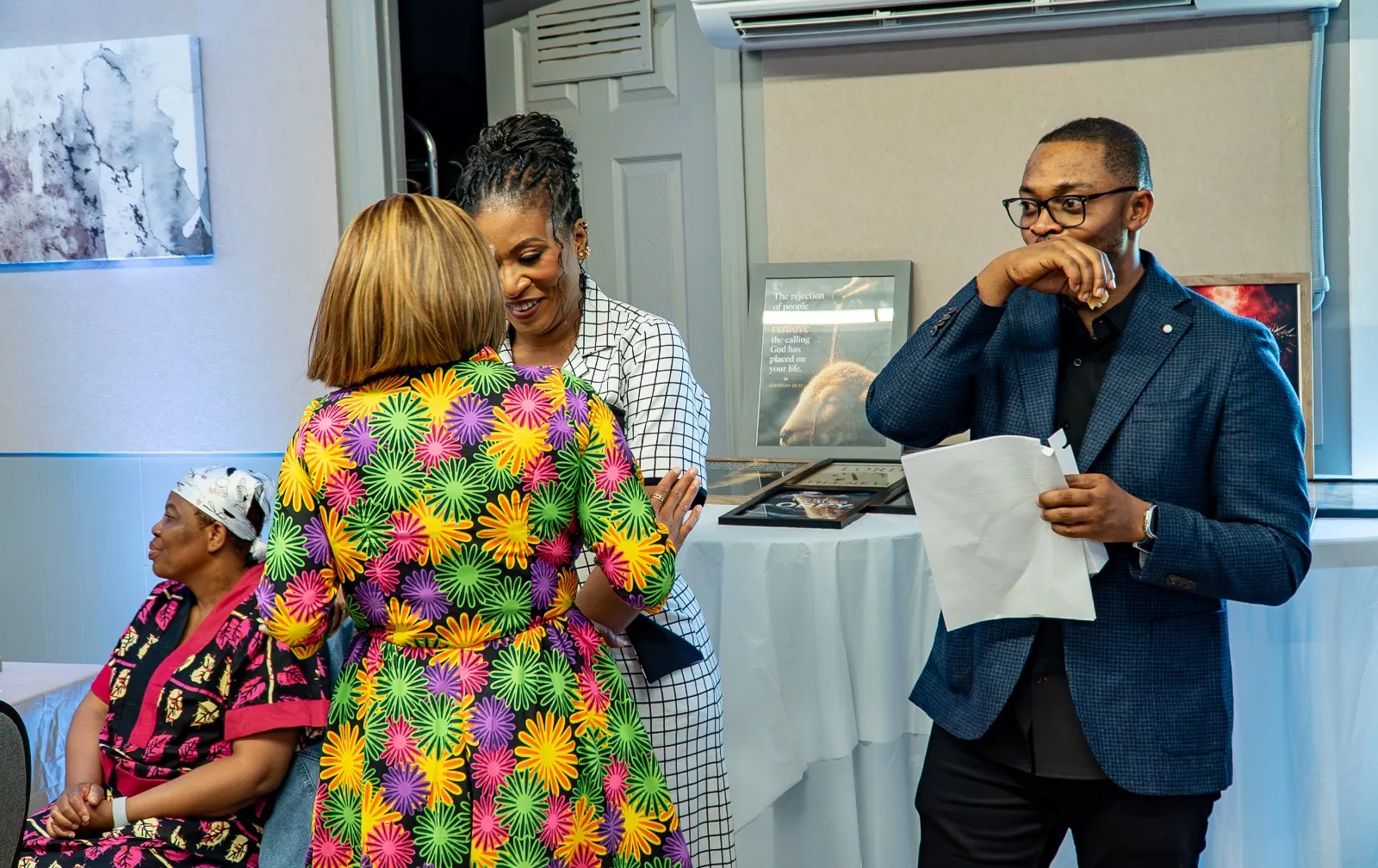 Members greeting and embracing one another during a gathering