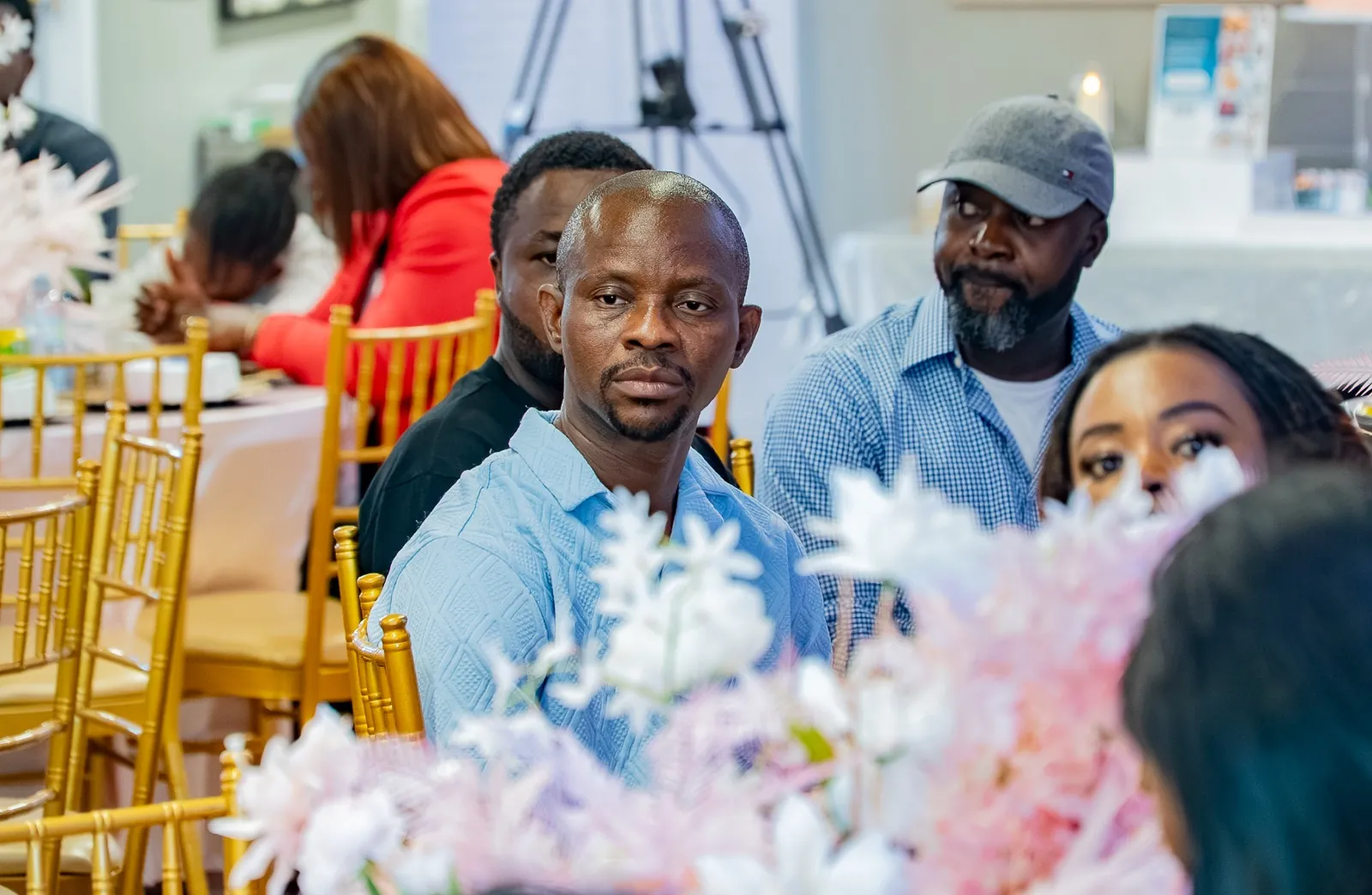 Members of the congregation seated at tables, listening attentively